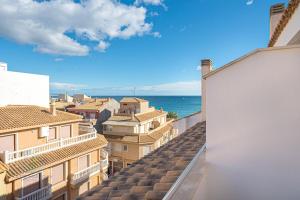 a view of the roofs of buildings and the ocean at Beachside Attico 3 bed 2 bath in El Campello