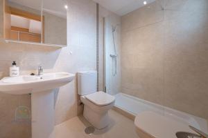 a bathroom with a sink and a toilet and a shower at Beachside Attico 3 bed 2 bath in El Campello +22 photos