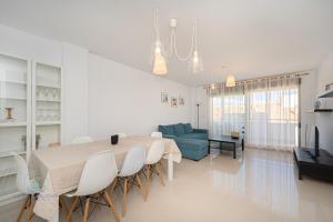 a living room with a table and a blue couch at Beachside Attico 3 bed 2 bath in El Campello