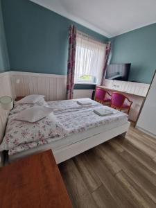 Łóżko lub łóżka w pokoju w obiekcie AGIS Pokoje Gościnne