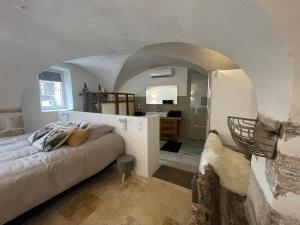 a bedroom with a bed and a bathroom with a mirror at Suite Ecurie in Vic-le-Comte