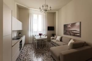 a living room with a couch and a table at Alighieri Theatre Charming Suite in Ravenna