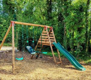 a playground with two swings and a ladder at Les Écuries in Empuré