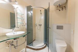 a bathroom with a shower and a toilet and a sink at OÁZIS Hotel*** in Nagykanizsa