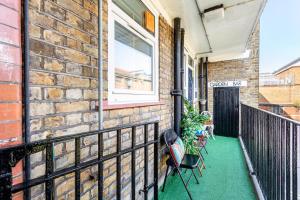 a balcony of a brick building with a window at Ultra Luxury London w Kensington balcony condo in London
