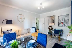 a living room with a couch and blue chairs at Ultra Luxury London w Kensington balcony condo in London