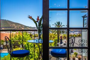 a view from a window of a table and chairs at Cape Riviera Guesthouse in Cape Town