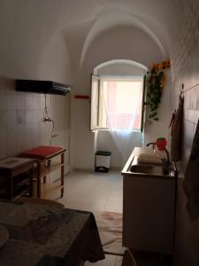 a small kitchen with a sink and a window at Domus 34 in Sassari