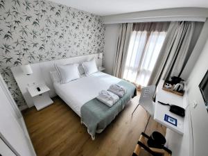 Postel nebo postele na pokoji v ubytování Hotel Monte Rozas + 48 fotografií