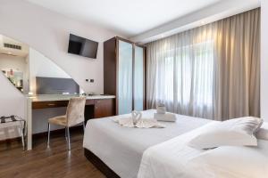 a hotel room with a bed and a desk at Aston Hotel in Pino Torinese