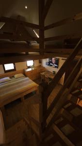 a room with a bed and a television in it at Lake house Amur in Kočevje +3 photos