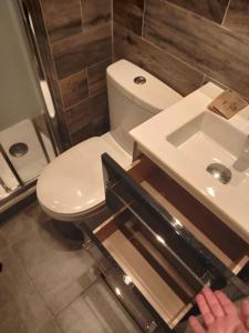a bathroom with a white toilet and a sink at Hotel Modern Est in Paris