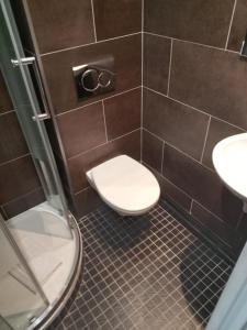 a bathroom with a toilet and two sinks at Hotel Modern Est in Paris