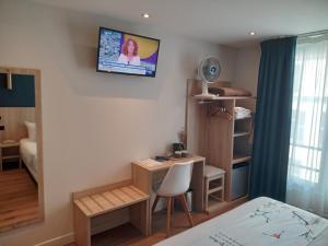 a small room with a bed and a desk at Hotel Modern Est in Paris