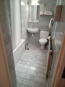 a bathroom with a toilet and a sink at Hotel Modern Est in Paris