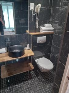 a bathroom with a toilet and a sink and a mirror at Hotel Modern Est in Paris