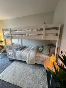 two bunk beds in a room with a table at Cosy ensuite in heart of city in Dublin
