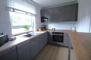 a kitchen with a sink and a stove top oven at Ferienhaus mit Garten in Bad Schwartau für bis zu 6 Personen in Bad Schwartau