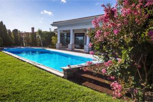 a swimming pool in the yard of a house at Luxury Villa with Pool- 4 Bedrooms in BlackSeaRama by Flat Mаnаger in Varna City
