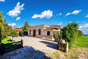 a house with a fence in front of it at Luxury Villa with Pool- 4 Bedrooms in BlackSeaRama by Flat Mаnаger in Varna City