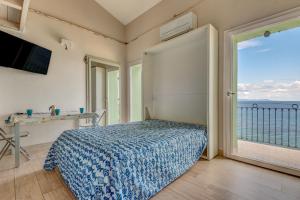 a bedroom with a bed and a view of the ocean at Residenza Rio Marina de luxe in Rio Marina