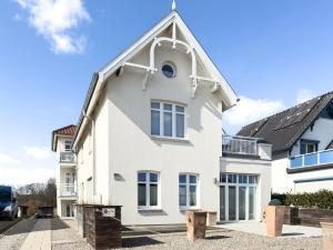 a white house with a gambrel roof at Ferienwohnung Baltic Lounge 53 in Haffkrug