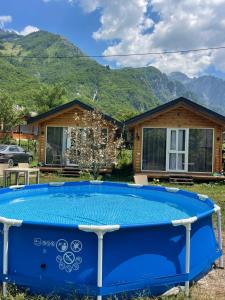 a pool in front of a house with mountains at Thethi Mountain Villas in Theth