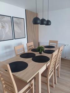 a wooden table with chairs and a dining room at Wieliczka4You in Wieliczka +14 photos