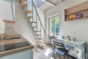 a kitchen and dining room with a spiral staircase at Residenza Rio Marina de luxe in Rio Marina