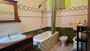 a bathroom with a tub and a sink and a toilet at Casa Terranova in Ustica