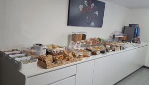 a buffet with bread and pastries on a counter at Beira Rio do Gerês in Geres