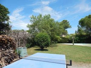 a ping pong table in a yard with trees at Maison de vacances avec piscine à 20min des plages in Castelnau-le-Lez