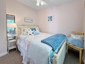 a bedroom with a bed with a blue comforter at Sweet Beach Retreat home in Wells