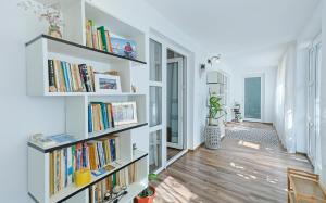 a room with white shelves filled with books at Casa EMMA in Jurilovca
