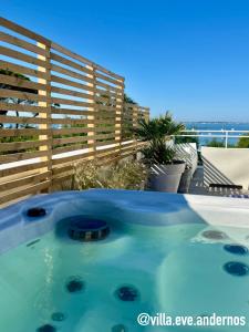 a swimming pool with a view of the ocean at VILLA EVE Bord de plage spa piscine roof top in Andernos-les-Bains