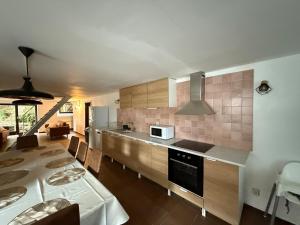 a kitchen with a counter and a table with a table sidx sidx at Le foyer ardennais in Trois-Ponts