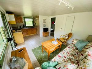 a living room with a couch and a table at Bungalow Guilietta in Göhren-Lebbin