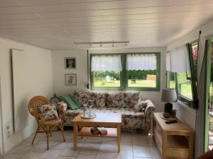 a living room with a couch and a table at Bungalow Guilietta in Göhren-Lebbin
