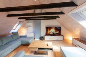 a living room with a couch and a tv at Ferienhaus Holzwurm in Braunlage