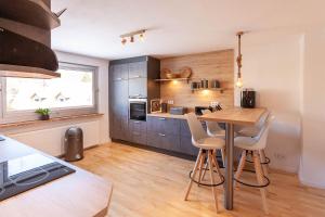 a kitchen with a table and chairs in a room at Ferienhaus Holzwurm in Braunlage