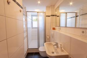 a bathroom with a sink and a toilet and a shower at Ferienhaus Holzwurm in Braunlage +24 photos