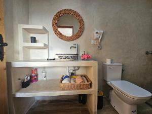 a bathroom with a sink and a toilet and a mirror at Casa de Mima, Casa Rural in Restinga Smir +17 photos
