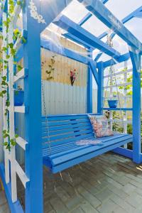 a blue swing on a patio at Casa EMMA in Jurilovca