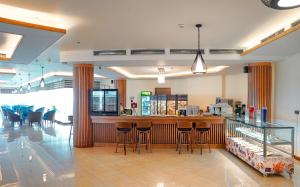 a restaurant with a bar with stools at BAYWATCH Cox's Bazar in Cox's Bazar
