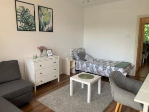 a living room with a couch and a table at Kat &Suzie in Suwałki