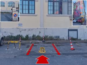 a parking lot with orange cones and a red arrow at Casa Mille Baci con Parcheggio in Livorno