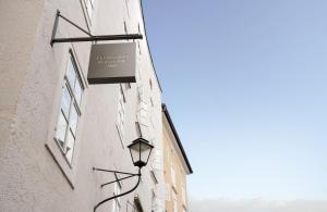 a street light attached to the side of a building at Leonardo Boutique Hotel Salzburg Gablerbräu in Salzburg