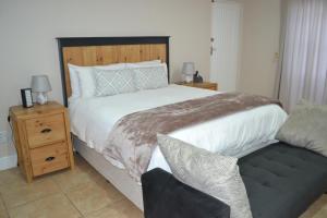 a bedroom with a large bed and a couch at The Starling Room in East London