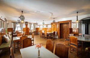 a dining room with wooden tables and chairs at Leonardo Boutique Hotel Salzburg Gablerbräu in Salzburg