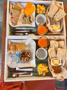 a refrigerator filled with lots of different types of food at La Maison Verte in Le Tampon